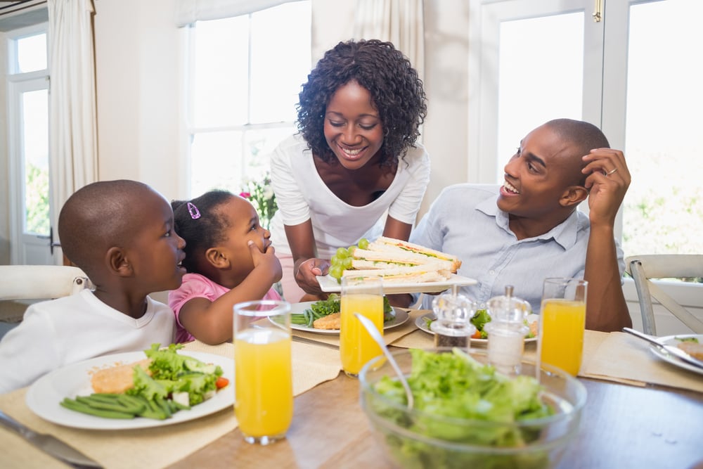 Happy family enjoying a healthy meal together at home in the kitchen-1